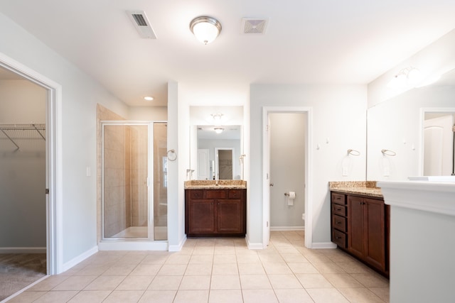 7217 Mossy Creek Ln, Hanahan, SC 29410 - bathroom featuring a shower stall, vanity, a walk in closet, tile patterned flooring, and baseboards