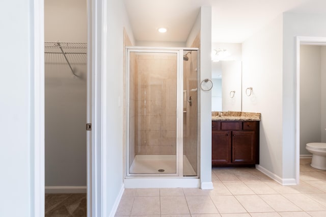 7217 Mossy Creek Ln, Hanahan, SC 29410 - full bath featuring a spacious closet, vanity, a shower stall, tile patterned floors, and toilet