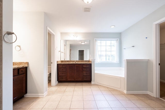 7217 Mossy Creek Ln, Hanahan, SC 29410 - bathroom featuring vanity, a garden tub, toilet, and tile patterned flooring