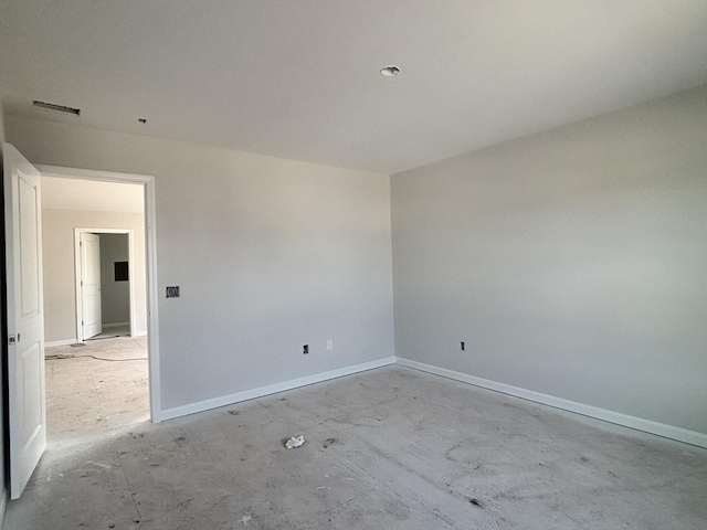 unfurnished room featuring visible vents and baseboards