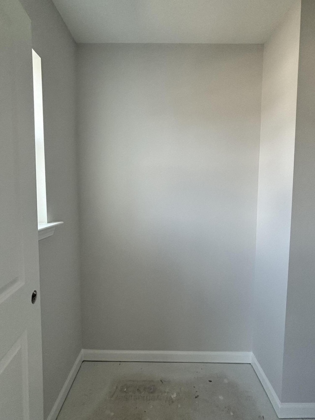 unfurnished room featuring baseboards