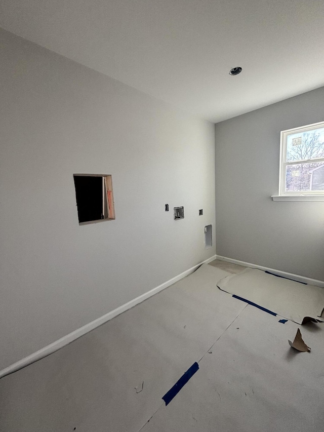 clothes washing area with laundry area and baseboards