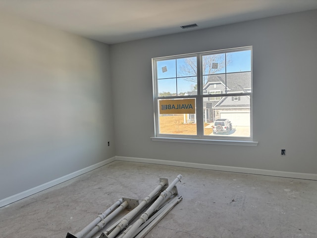 spare room with baseboards and visible vents