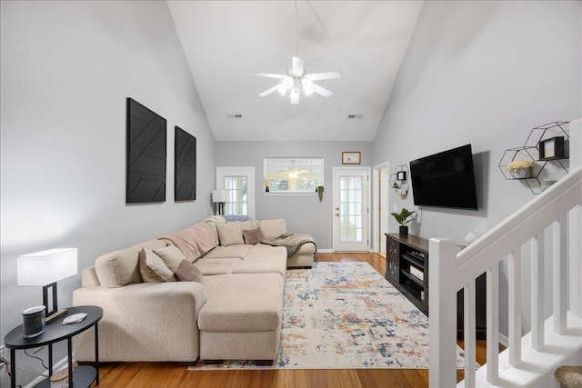 living area featuring high vaulted ceiling, wood finished floors, visible vents, and ceiling fan