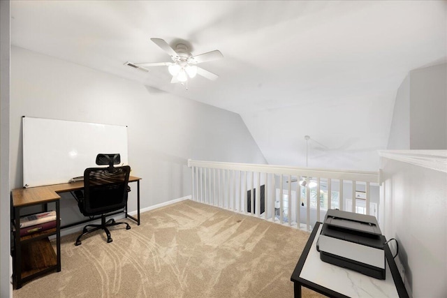 carpeted home office with lofted ceiling, a ceiling fan, and visible vents