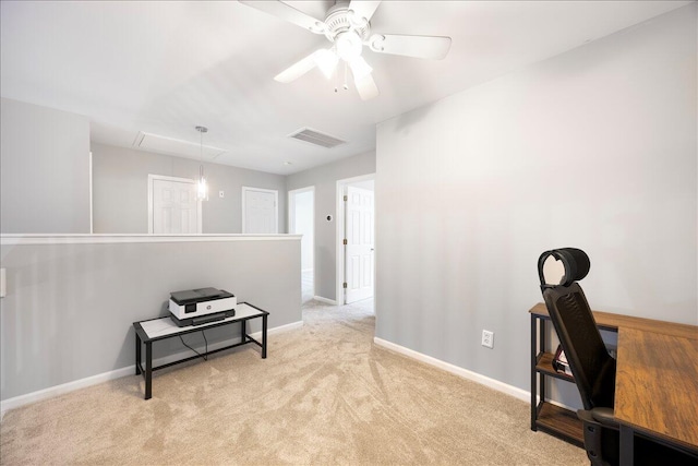 home office with visible vents, light carpet, baseboards, attic access, and ceiling fan