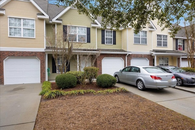 multi unit property with brick siding, a garage, driveway, and roof with shingles