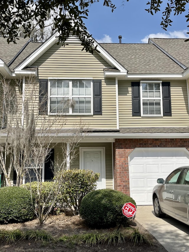 townhome / multi-family property featuring a garage, brick siding, roof with shingles, and driveway