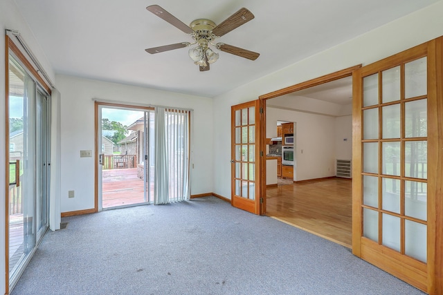 1023 Striper Ave, Moncks Corner, SC 29461 - spare room with french doors, carpet flooring, baseboards, and a ceiling fan