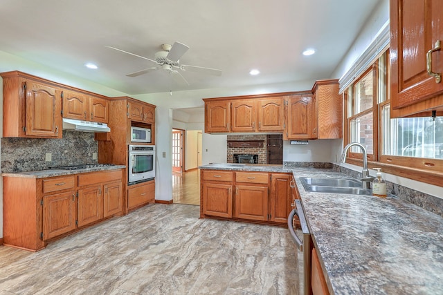 1023 Striper Ave, Moncks Corner, SC 29461 - kitchen featuring stainless steel appliances, a sink, a ceiling fan, brown cabinetry, and recessed lighting