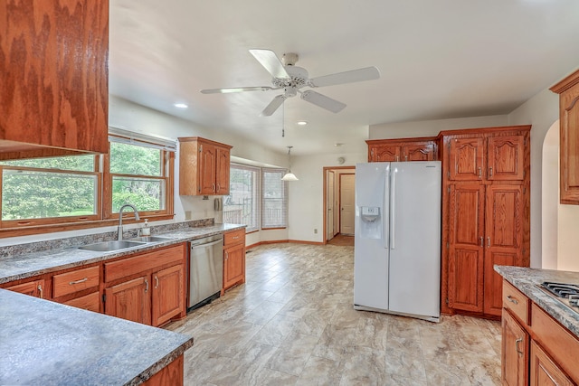1023 Striper Ave, Moncks Corner, SC 29461 - kitchen with stainless steel appliances, a sink, a ceiling fan, brown cabinetry, and decorative light fixtures