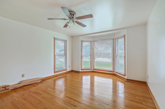 1023 Striper Ave, Moncks Corner, SC 29461 - spare room with light wood-type flooring, a ceiling fan, and baseboards