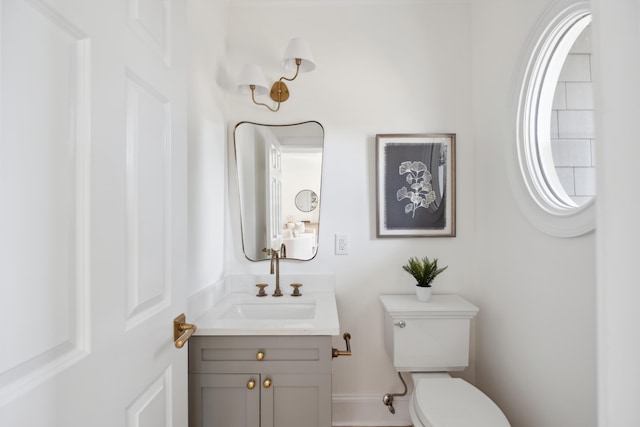 half bathroom featuring toilet and vanity