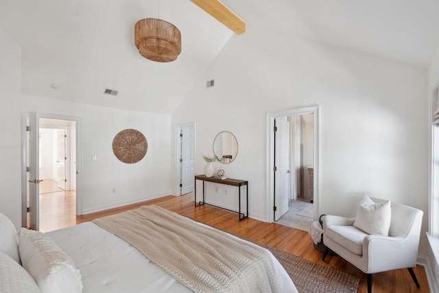 bedroom with visible vents, baseboards, high vaulted ceiling, and light wood finished floors