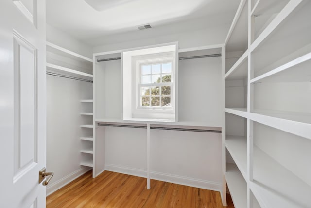 walk in closet featuring wood finished floors and visible vents