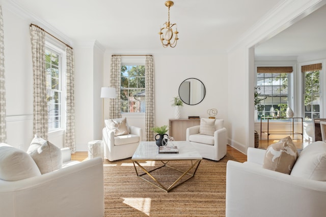 living room with a wealth of natural light, wood finished floors, and ornamental molding