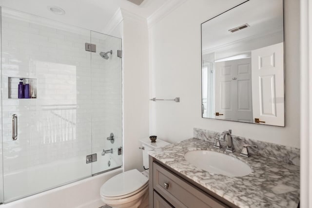 full bathroom featuring visible vents, toilet, crown molding, enclosed tub / shower combo, and vanity