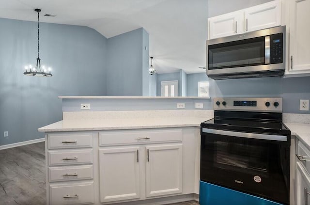426 Colony Dr, Ridgeland, SC 29936 - kitchen featuring appliances with stainless steel finishes, dark wood-type flooring, decorative light fixtures, an inviting chandelier, and white cabinets