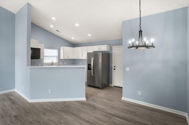 426 Colony Dr, Ridgeland, SC 29936 - kitchen featuring white cabinetry, stainless steel fridge with ice dispenser, kitchen peninsula, hardwood / wood-style floors, and decorative light fixtures