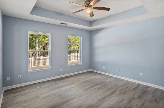 426 Colony Dr, Ridgeland, SC 29936 - unfurnished room featuring wood-type flooring, a raised ceiling, and ceiling fan
