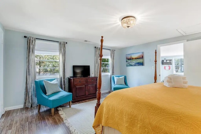 bedroom with wood-type flooring and multiple windows