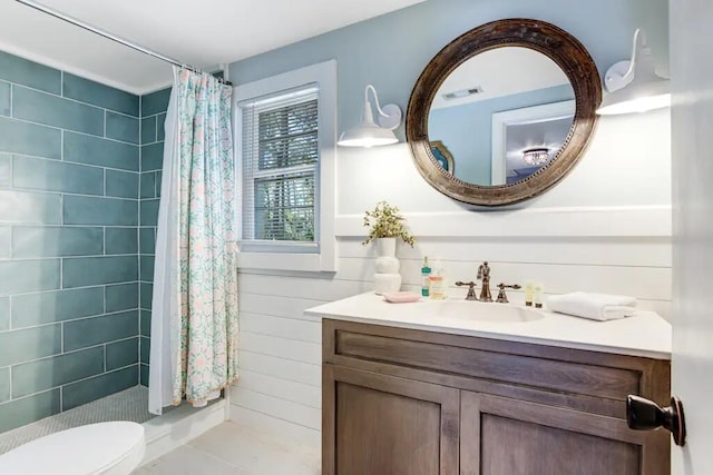 bathroom featuring vanity, curtained shower, and toilet