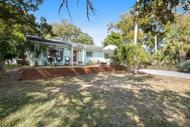 rear view of property featuring a yard