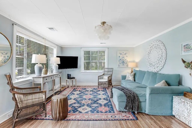 living room with crown molding and hardwood / wood-style flooring