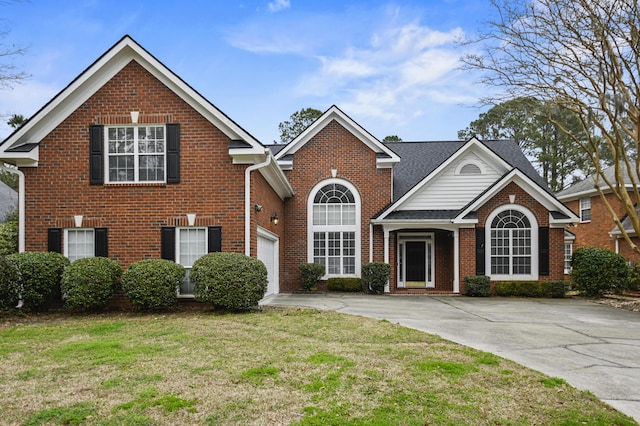 traditional-style house featuring a garage, brick siding, driveway, and a front lawn