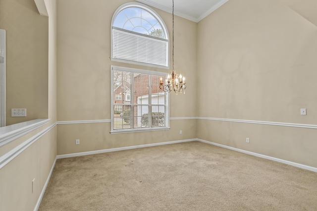 unfurnished room featuring a healthy amount of sunlight, a high ceiling, light colored carpet, and an inviting chandelier