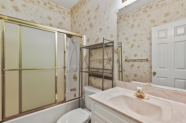 full bathroom with enclosed tub / shower combo, toilet, vanity, and wallpapered walls