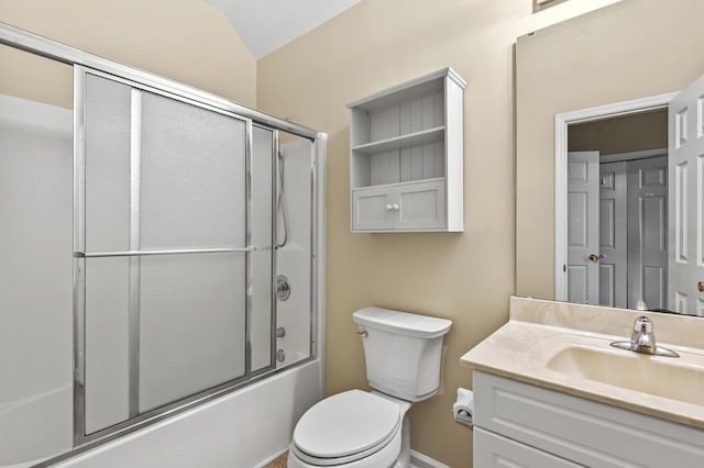 full bathroom featuring toilet, bath / shower combo with glass door, and vanity