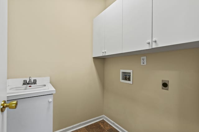 laundry room with cabinet space, baseboards, hookup for a washing machine, hookup for an electric dryer, and a sink