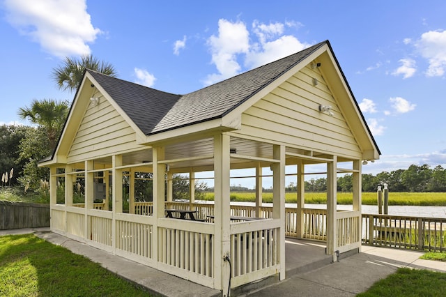 view of property's community featuring a water view and fence