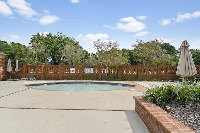 pool featuring a patio area and fence