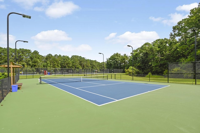 view of sport court featuring fence