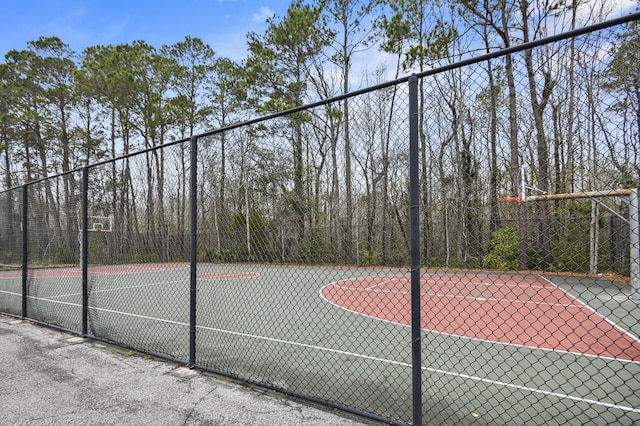 view of basketball court with community basketball court and fence