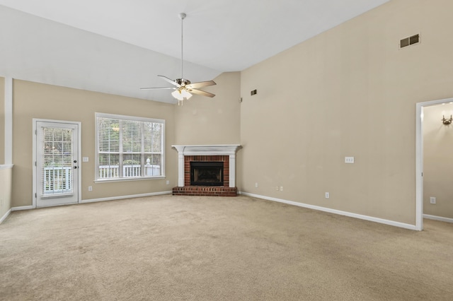 unfurnished living room with light carpet, visible vents, ceiling fan, a brick fireplace, and high vaulted ceiling