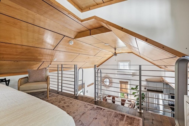 bedroom with wood finished floors, wooden ceiling, and vaulted ceiling