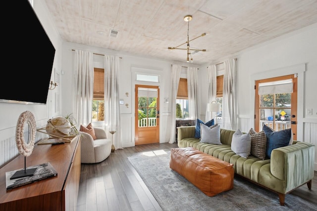 living room with hardwood / wood-style flooring, a chandelier, and wooden ceiling