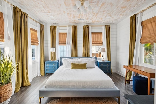 bedroom with a chandelier, wood finished floors, and wooden ceiling