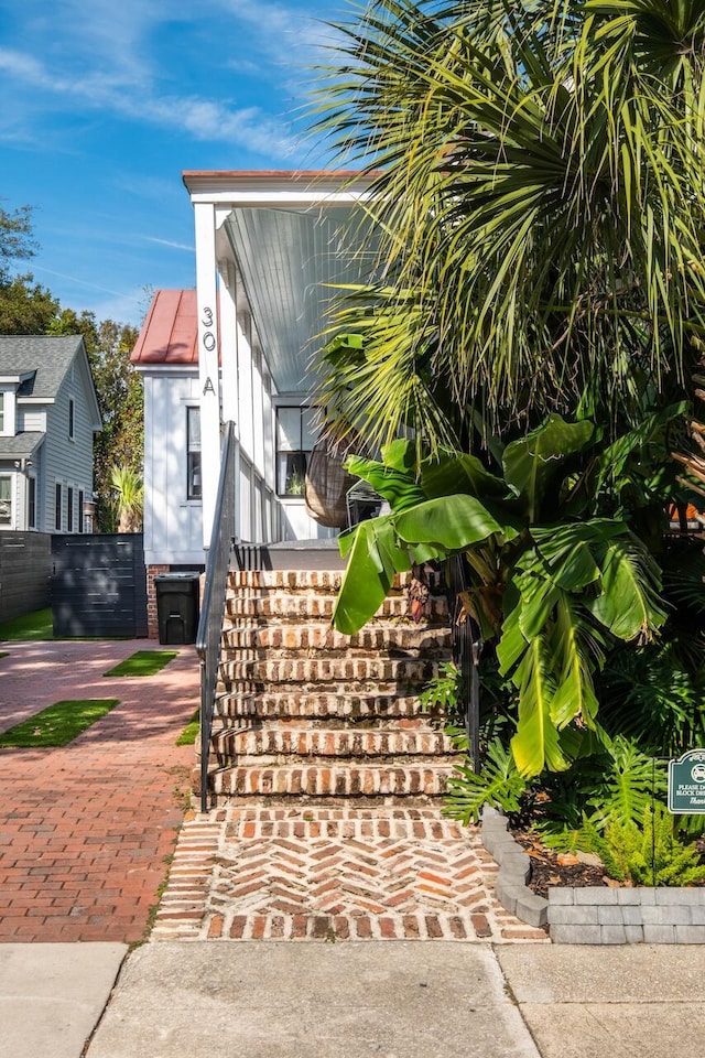 view of side of property featuring stairway
