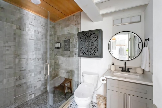 bathroom with toilet, a shower stall, and vanity