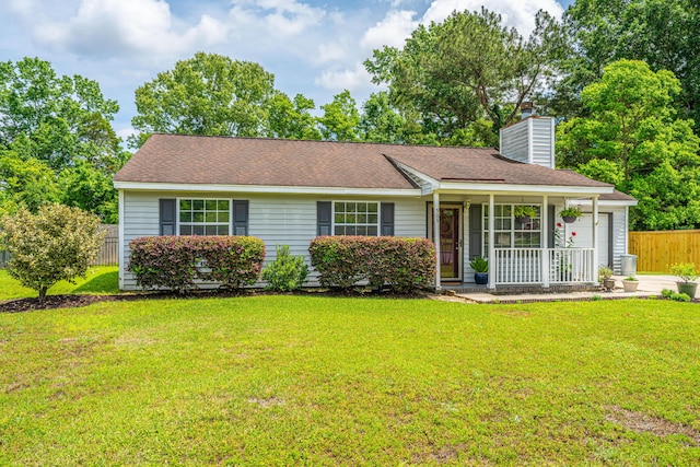 ranch-style home featuring fence, roof with shingles, a front lawn, a chimney, and covered porch