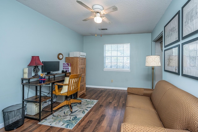 office featuring a textured ceiling, ceiling fan, wood finished floors, and visible vents