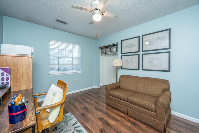 office with a textured ceiling, a ceiling fan, baseboards, wood finished floors, and visible vents