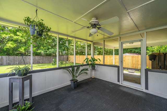 unfurnished sunroom with ceiling fan