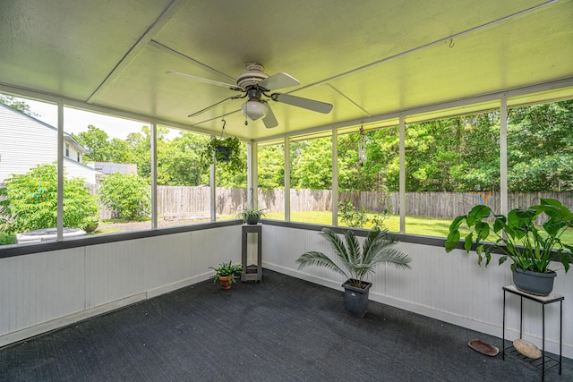 unfurnished sunroom with ceiling fan