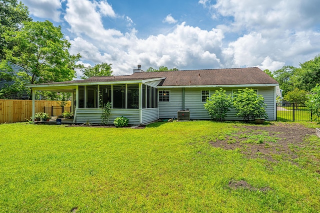 back of property featuring a yard, central AC, a fenced backyard, and a sunroom