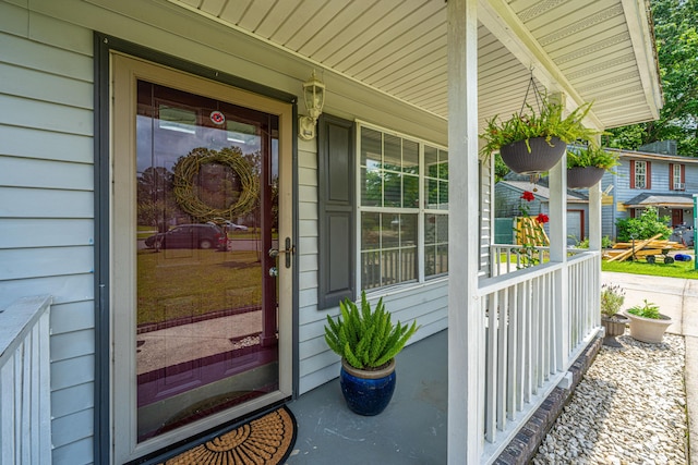 view of exterior entry featuring a porch